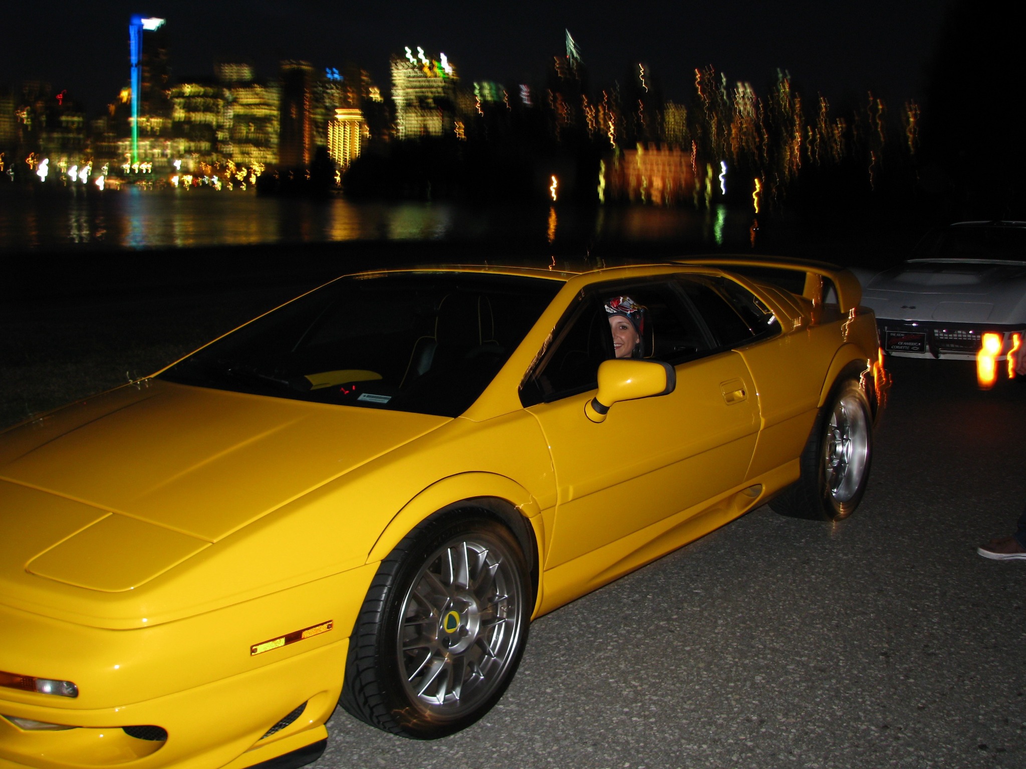 Yellow 2002 Lotus Esprit V8 25th Anniversary Edition beside the waterfront at night