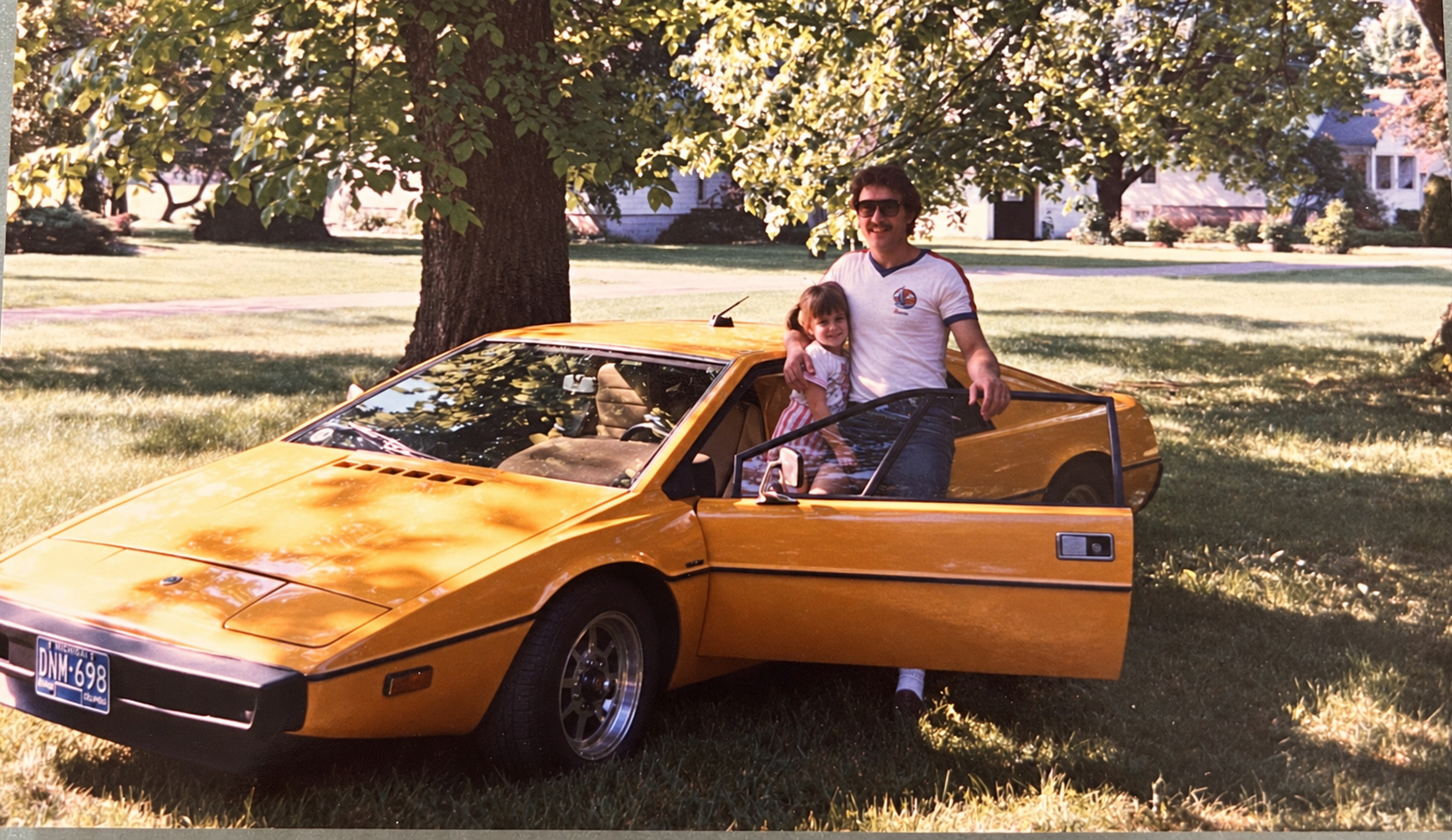An early photograph of the Lotus Esprit with two people beside the open door